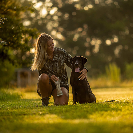 Photo of girl and dog in retriever trainer